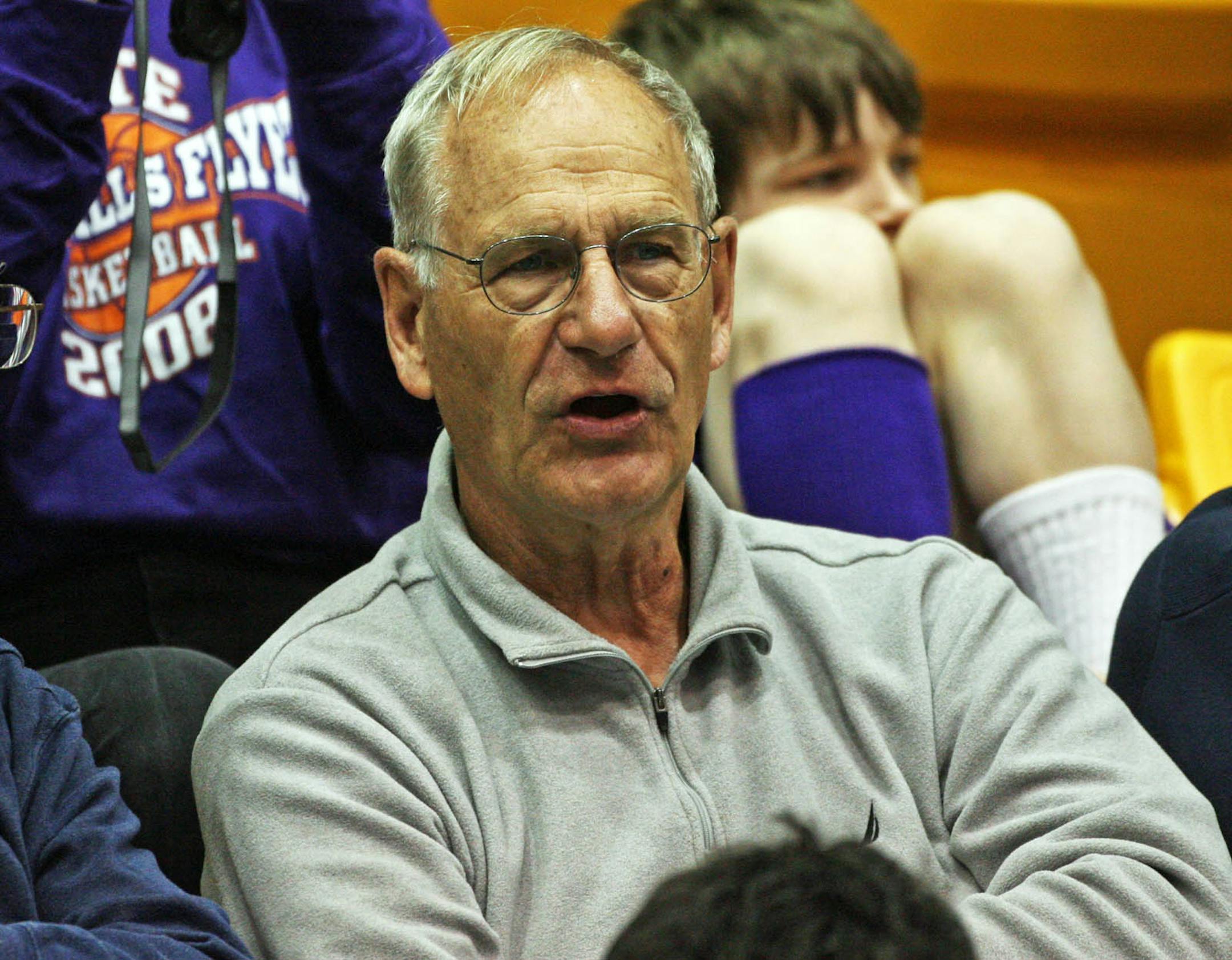 Ron Johnson watches his grandsons play basketball for Little Falls.