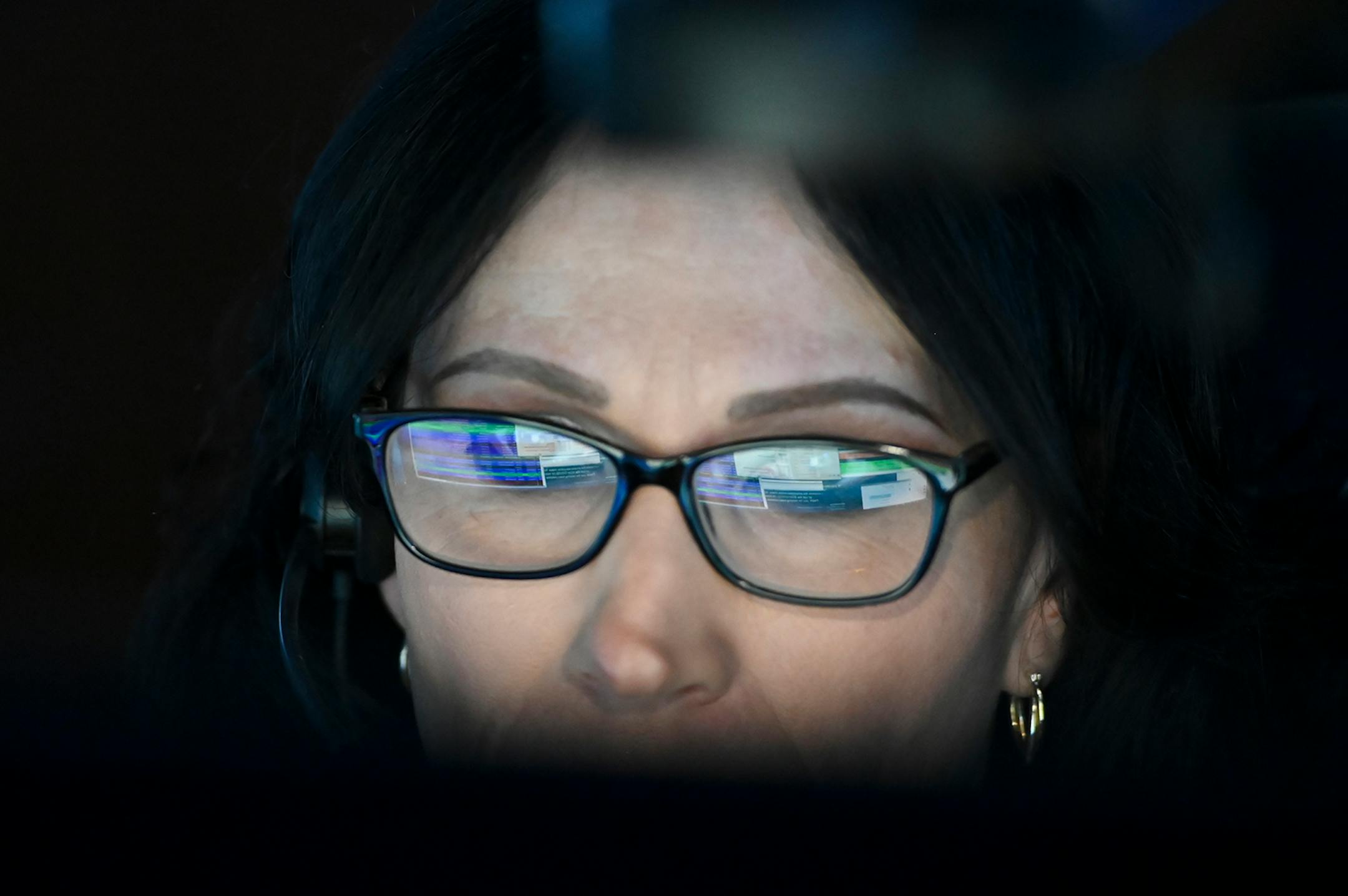 Computer screens were reflected in the glasses of Allina EMS dispatcher Jessica Rodriguez during her shift Wednesday morning. ] AARON LAVINSKY • aaron.lavinsky@startribune.com Emergency medical workers and physician Andrew Stevens responded to possible COVID-19 related calls on Wednesday, Dec. 2, 2020 in the north Twin Cities metro.