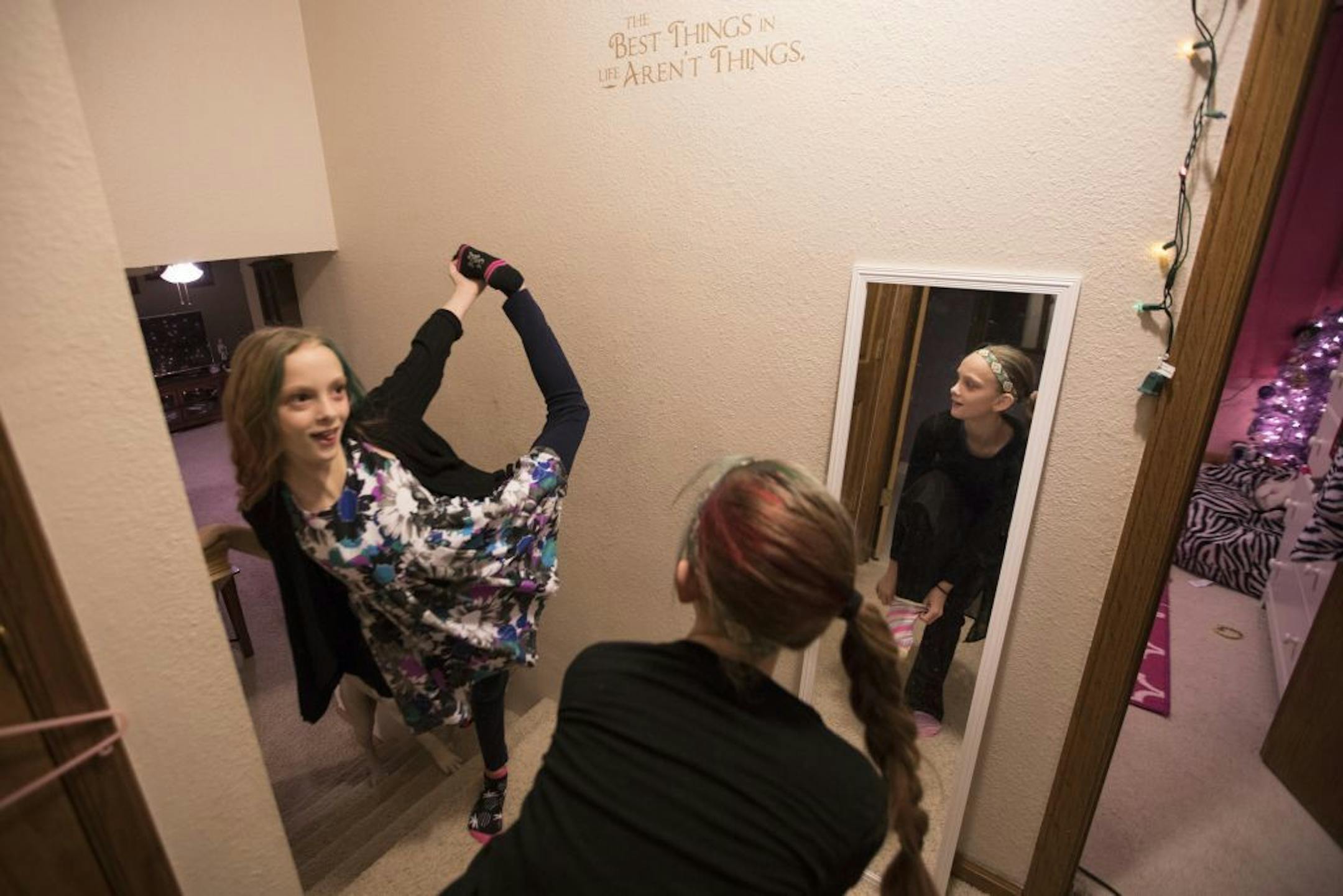 Isabelle, right, and Abby Carlsen play around while getting ready for school in the morning.