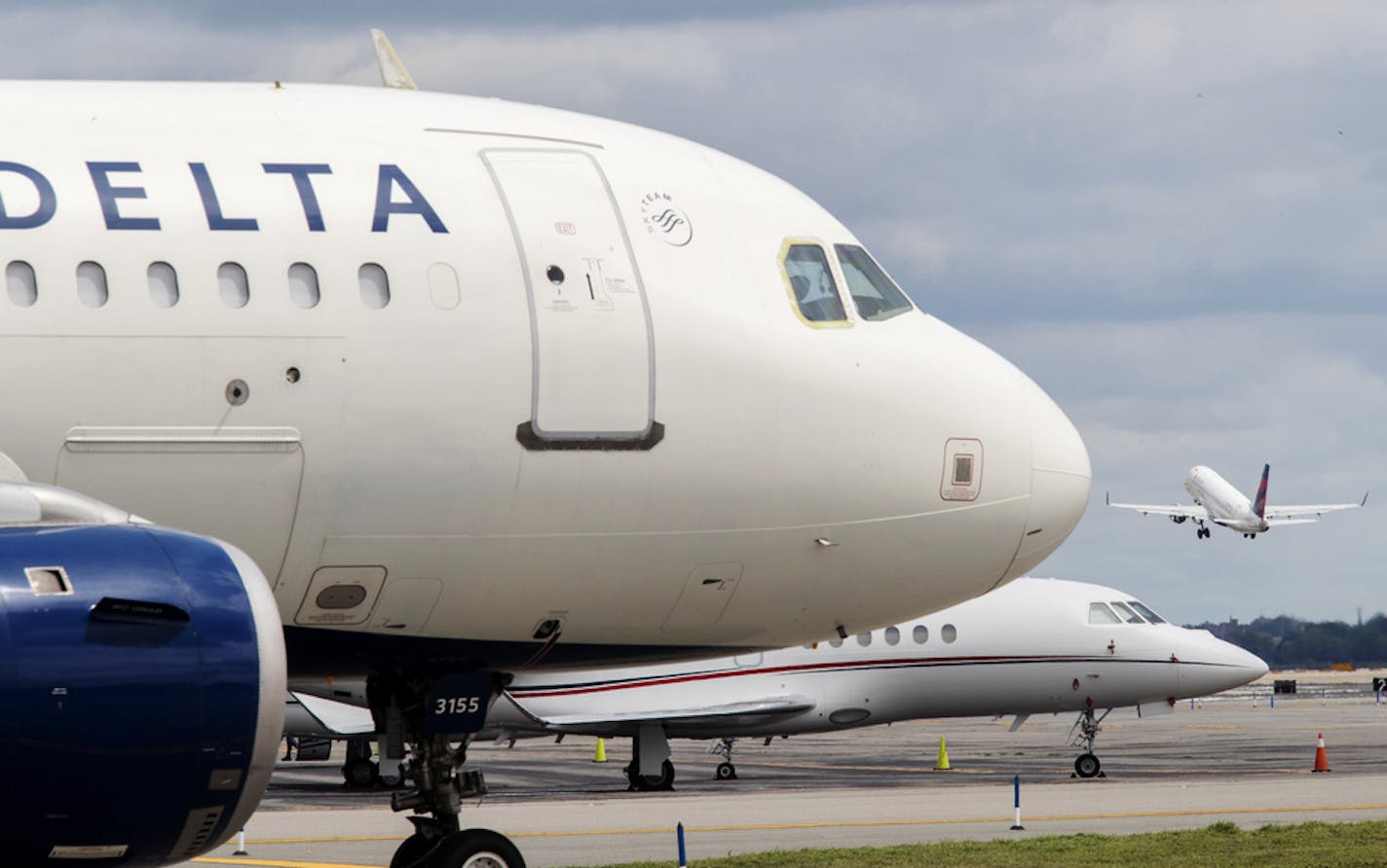 FILE - In this Aug. 8, 2017, file photo, a Delta Air Lines jet waits on the tarmac at LaGuardia Airport in New York. Delta tops an annual study that ranks US airlines by on-time arrivals, complaint rates, and other statistical measurements. Researchers who crunch the numbers say that U.S. airlines are getting better as a whole. (AP Photo/Mary Altaffer, File)