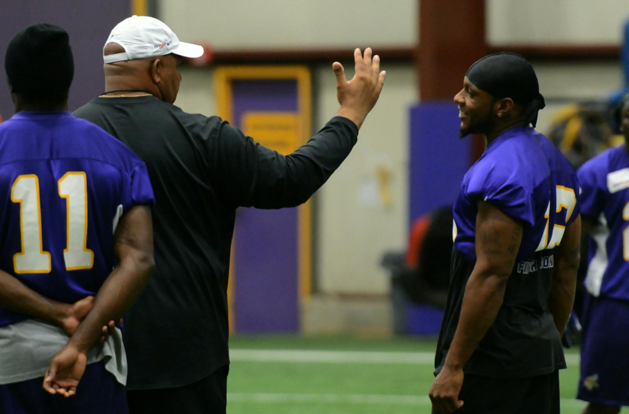 Percy Harvin, right, and assistant coach (wide receivers) George Stewart, left, talk during practice Wednesday morning at Winter Park in Eden Prairie. ] (DAVID BREWSTER/STAR TRIBUNE) ** Percy Harvin (#12, team roster), George Stewart (coaches roster)