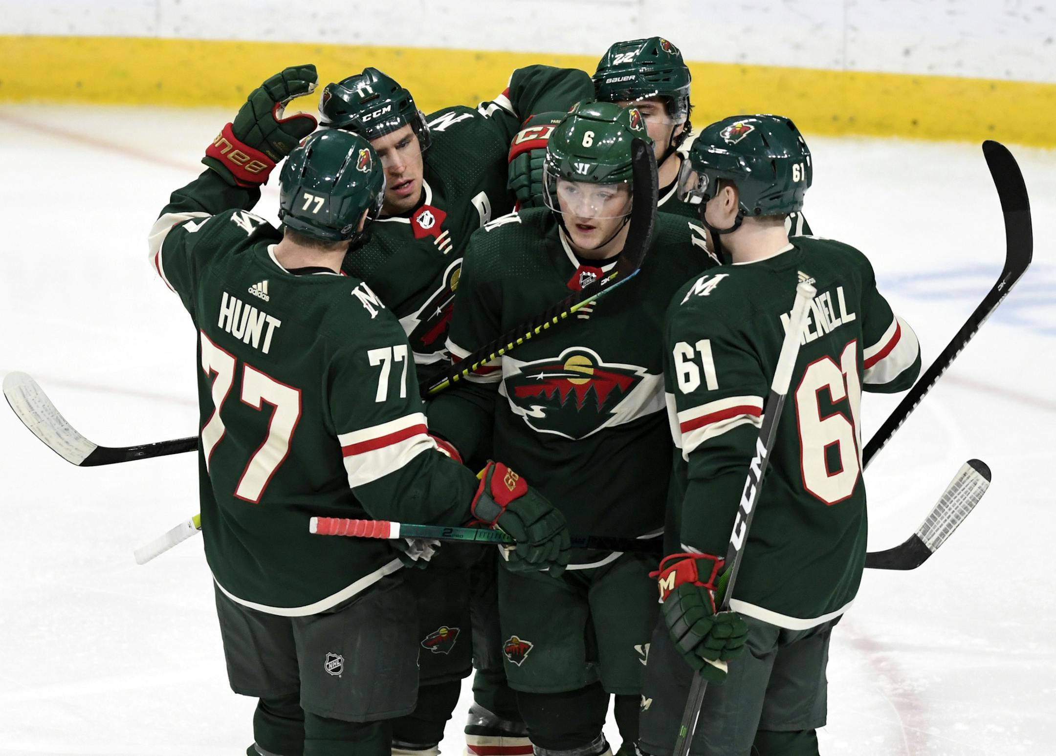 Minnesota Wild's Ryan Donato, center, breaks the team huddle after scoring against the Anaheim Ducks in the third period of an NHL hockey game, Tuesday, Dec. 10, 2019, in St. Paul, Minn. Anaheim won 3-2.(AP Photo/Tom Olmscheid)