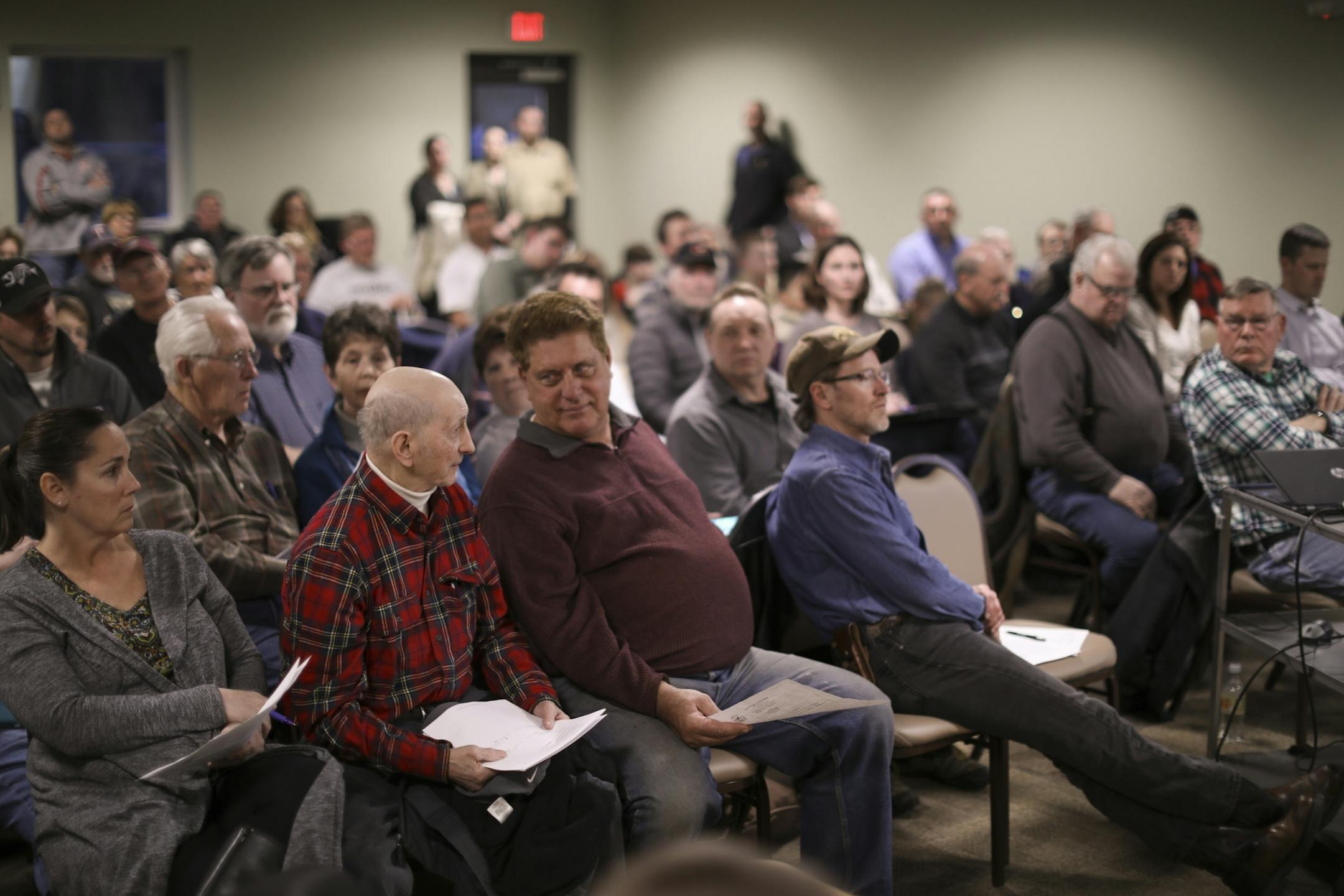 Melvin Pfaffendorf, plaid shirt in the foreground, a lifelong resident of Linwood Township, asked a question of one of the presenters at the township's annual meeting Tuesday night.