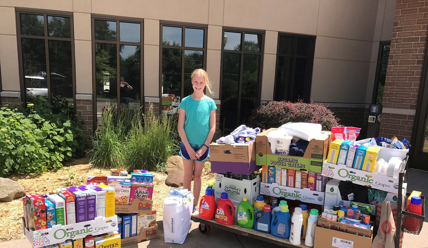 Eleanor Donley, 11, with some of the donations to Our Saviour's Housing ­collected during a drive she organized at Christ Lutheran Church in Blaine.