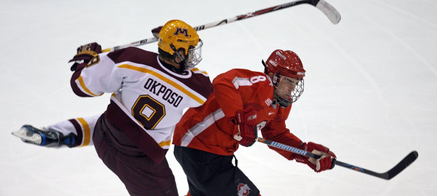 BRUCE BISPING � bbisping@startribune.com Minneapolis, MN., Friday, 10/26/2007. Gophers vs Ohio State. (left to right) Goohers Kyle Okposo and Ohio State's Tom Fritsche battled for a puck in first period action.