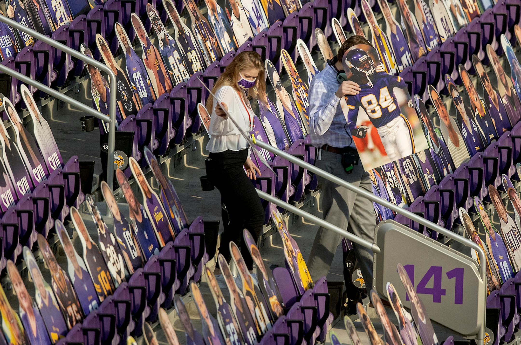 A cut-out of Randy Moss got carried down into the stands to be placed in a seat before the game.