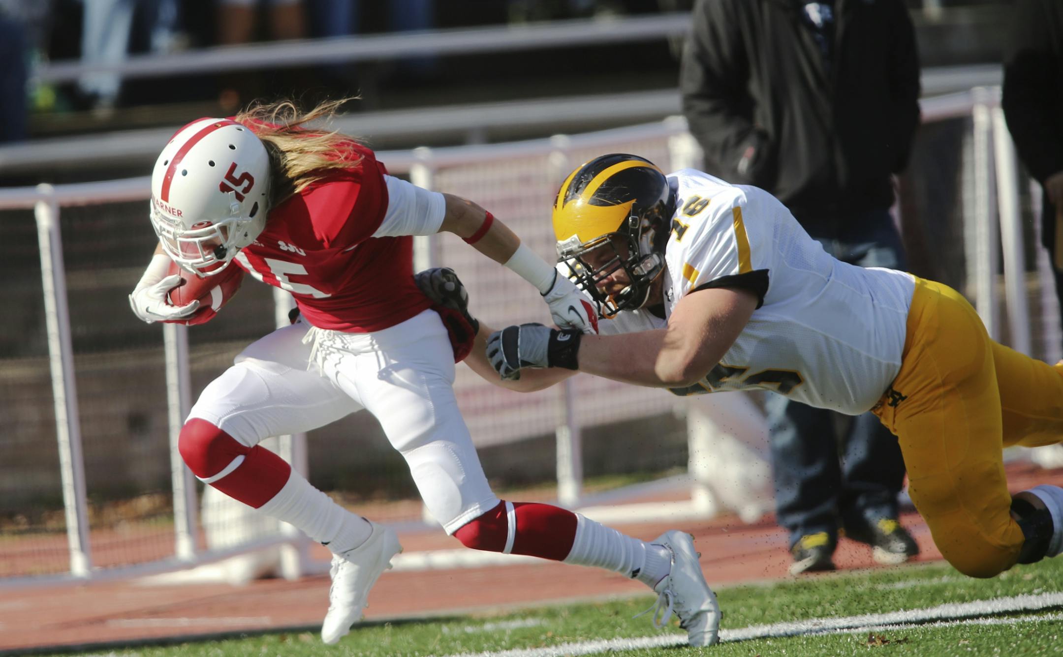 St. John's Trevor Warner is tackled by Gustavus Adolphus' Brian Grundmeyer.