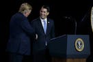 President Donald Trump shakes hands with Gov. Scott Walker, R-Wis., during remarks to a Foxconn facility, Thursday, June 28, 2018, in Mt. Pleasant, Wi
