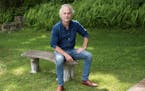 photo of author Amor Towles on a bench in a park