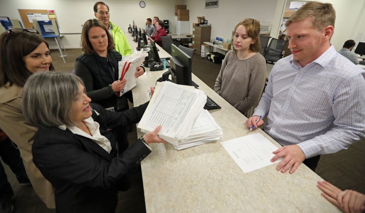 Patricia Hartmann dropped a stacked pile of petitions on the desk in front of elections specialist Josh Kiley.