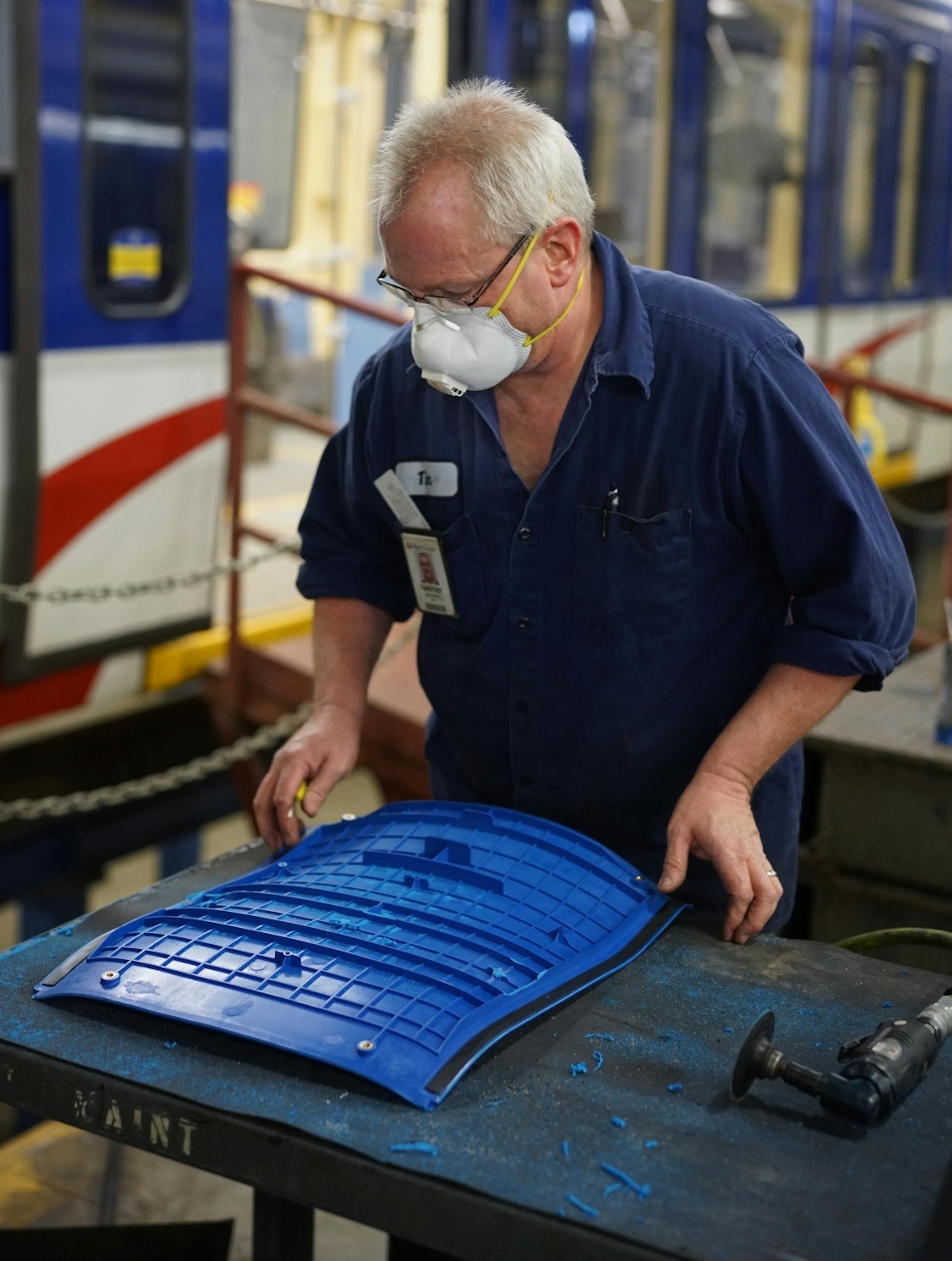 Electromechanical technician Timothy Malmstedt disassembled old cloth seats and installed new plastic seats as part of a test program to try seats that are easier to maintain.