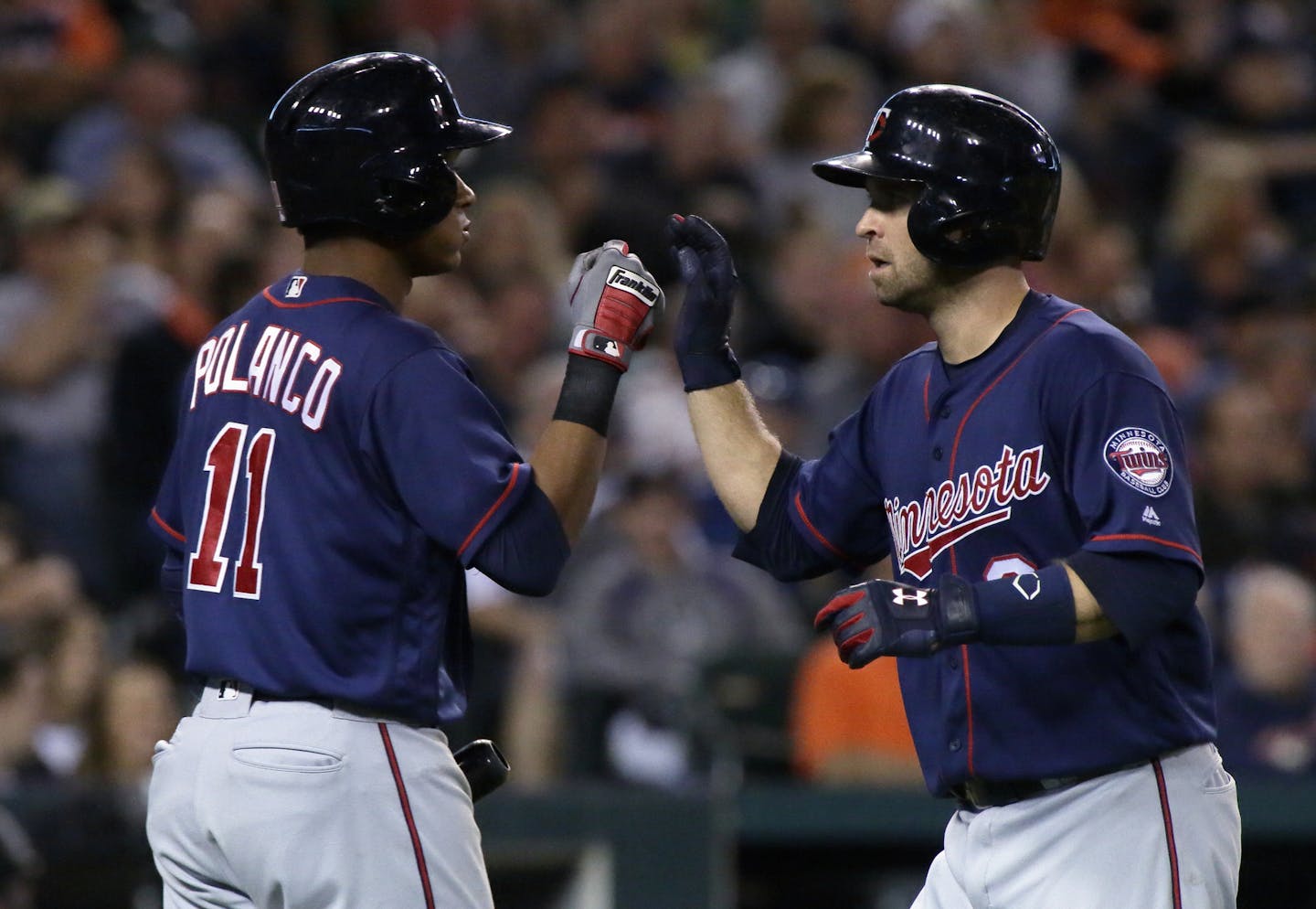 Minnesota Twins' Brian Dozier, right, is congratulated by Jorge Polanco after hitting a solo home run against the Detroit Tigers during the fourth inning of a baseball game Wednesday, Sept. 14, 2016, in Detroit. (AP Photo/Duane Burleson)