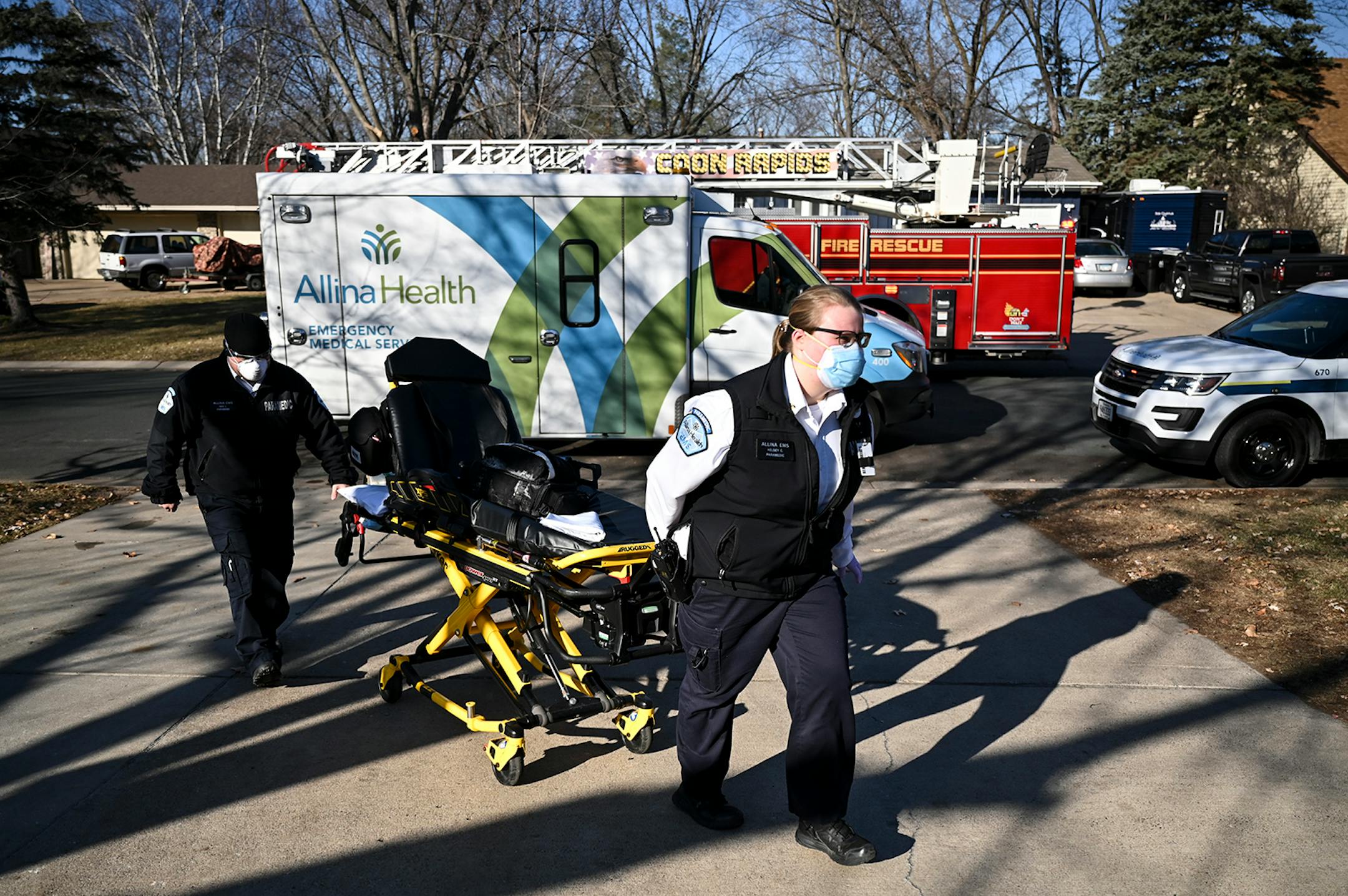 Allina Health paramedics Kelsey Cook, right, and Dan Lennartson arrived at a patient's home Wednesday, who was having a possible COVID-19-related medical emergency. ] AARON LAVINSKY • aaron.lavinsky@startribune.com Emergency medical workers and physician Andrew Stevens responded to possible COVID-19 related calls on Wednesday, Dec. 2, 2020 in the north Twin Cities metro.