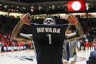 Nevada's Marcus Marshall (1) celebrates his team's win following the end of an NCAA college basketball game against New Mexico in Albuquerque, N.M., S