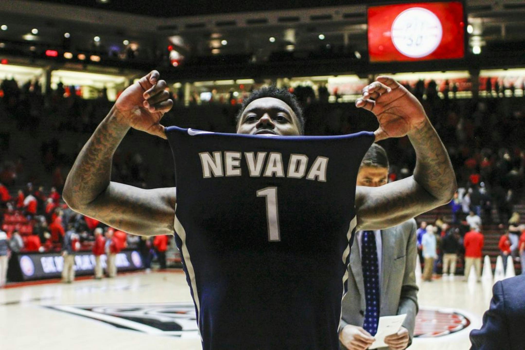 Nevada's Marcus Marshall (1) celebrates his team's win following the end of an NCAA college basketball game against New Mexico in Albuquerque, N.M., Saturday, Jan. 7, 2017. Nevada won in overtime 105-104.