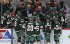 Minnesota Wild head coach Bruce Boudreau huddles with his players during a timeout in December.