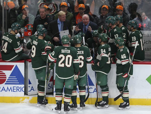 Minnesota Wild head coach Bruce Boudreau huddles with his players during a timeout in December.