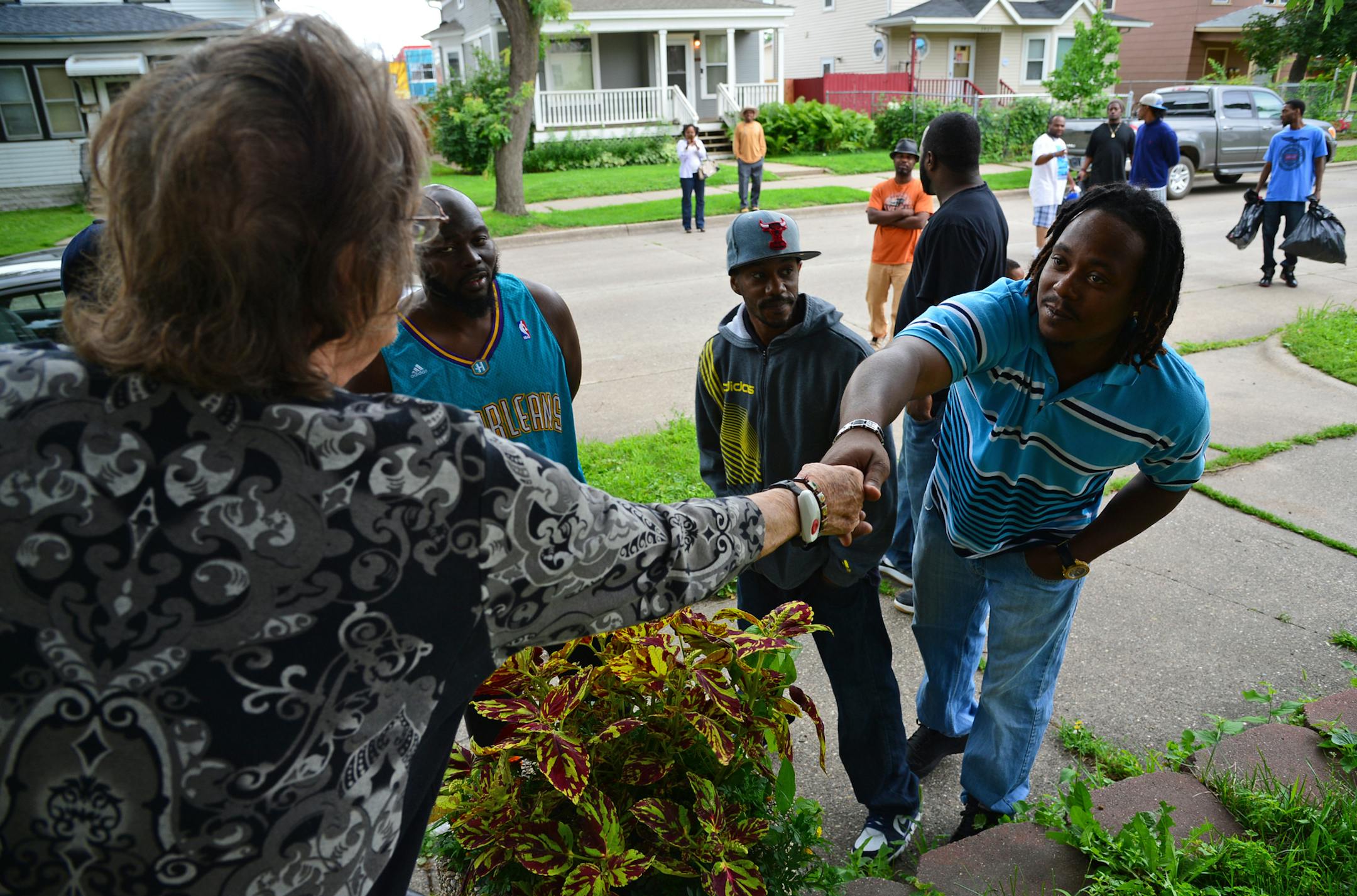 Rodney Shores of St Paul is a member of COY and greeted Katherine Hanson who has lived on Willow Ave in North Minneapolis for over 48 years .