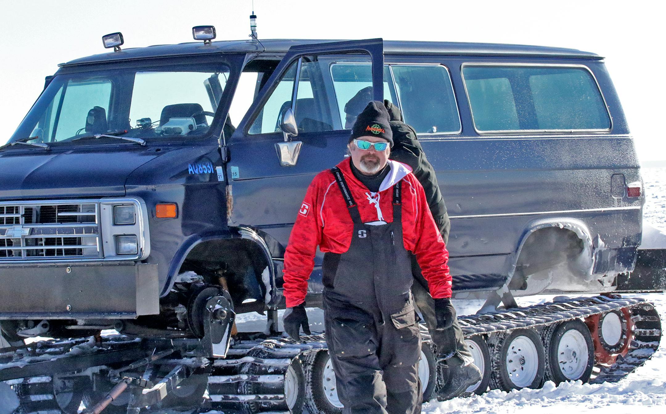 Tim "Wingnut" Hill of Arnesen's Rocky Point Resort checks on ice anglers miles away from shore on Lake of the Woods, east of Warroad. He worked in partnership with fellow crew member Dan Jesser, behind.