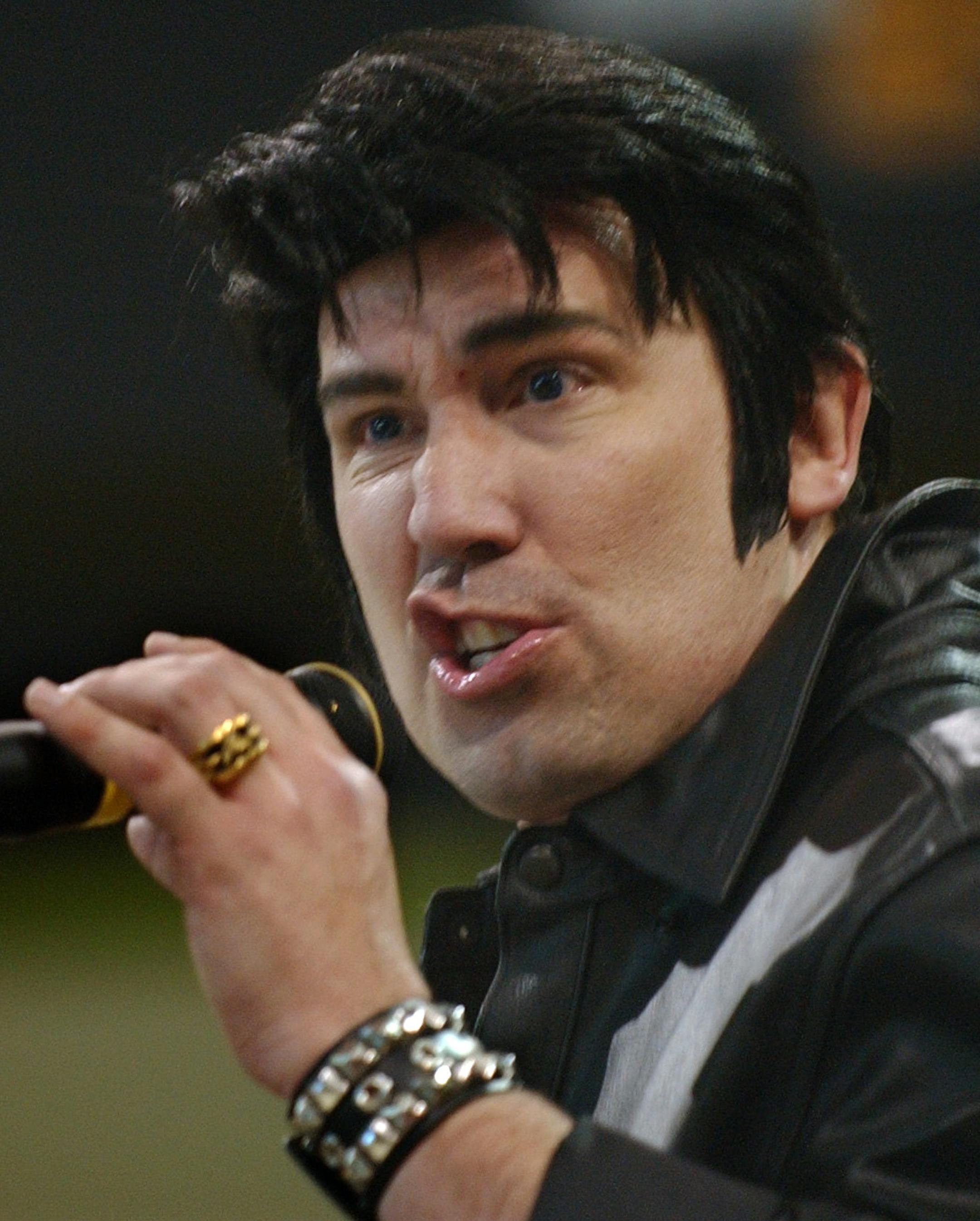 Bloomington,Mn.,Sat.,April 2, 2005--Todd Anderson sang with an Elvis curled lip. Anderson was the MC for the Contest of Kings at the Mall of America and performed several Elvis songs. He is from Burnsville,Mn.
GENERAL INFORMATION: Elvis impersonators competed in the Contest of Kings at the Mall of America benefiting the Greater Twin Cities United Way.