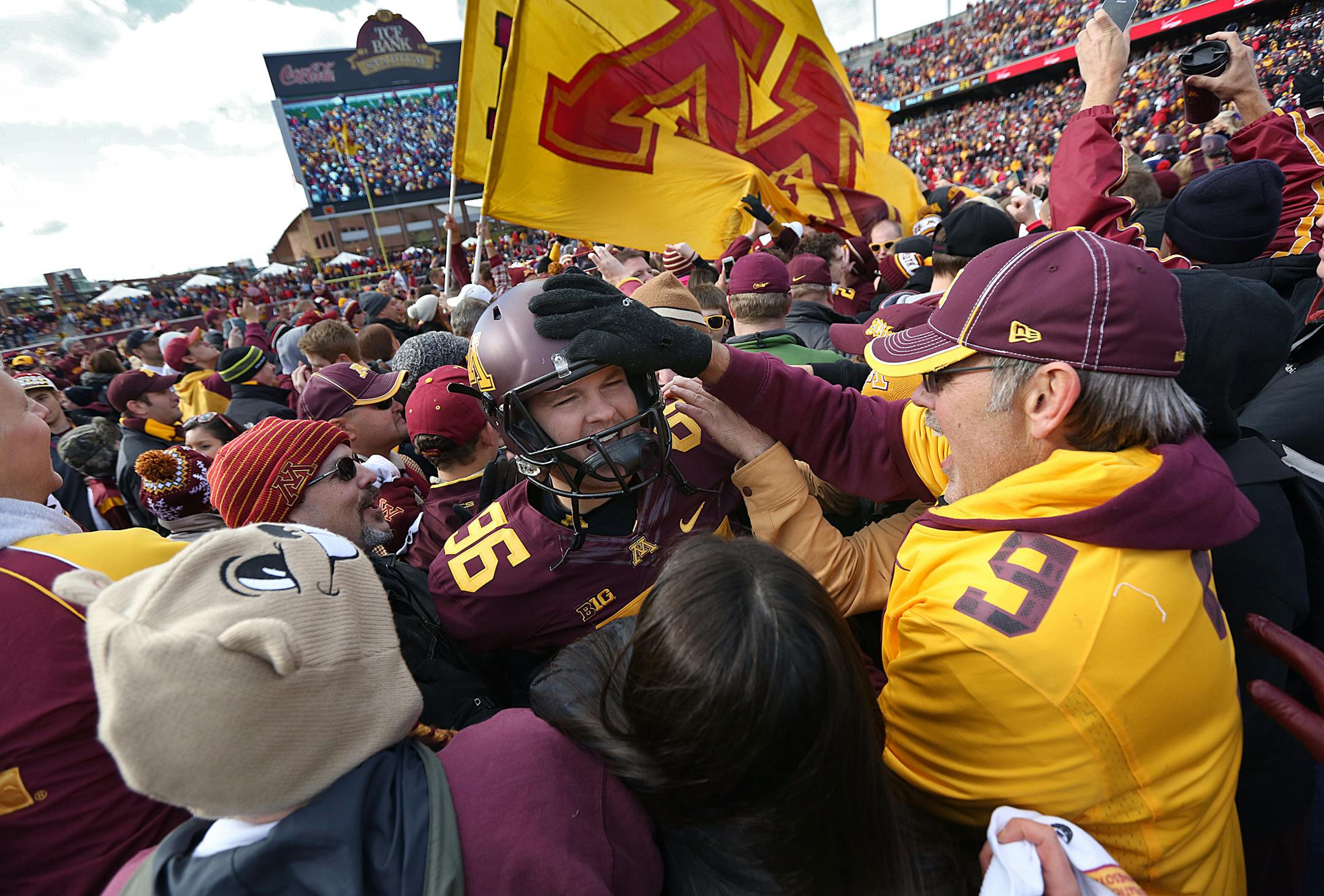 Gophers Jordan Hinojosa was mobbed by enthusiastic fans after the game. ]JIM GEHRZ • jgehrz@startribune.com Minneapolis, MN / Oct 27, 2013, 11:00 AM BACKGROUND INFORMATION- The Minnesota Golden Gopher football team played the Nebraska Cornhuskers at TCF Bank Stadium. Minnesota won, 34-23. ORG XMIT: MIN1310261719513037