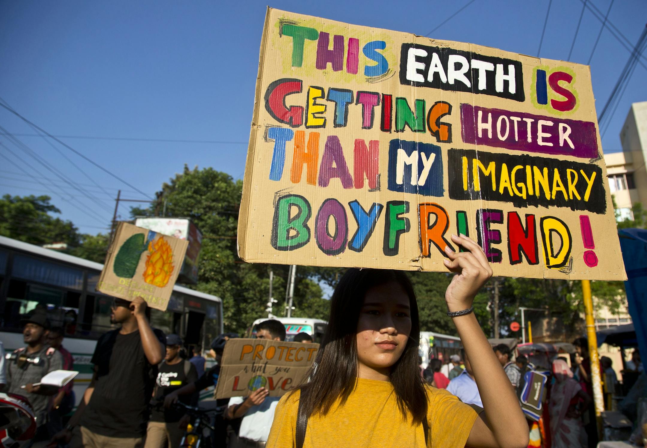Protesters hold placards and march on a street in Gauhati, India, Friday, Sept. 20, 2019. The protestors gathered in response to a day of worldwide demonstrations calling for action to guard against climate change began ahead a U.N. summit in New York.