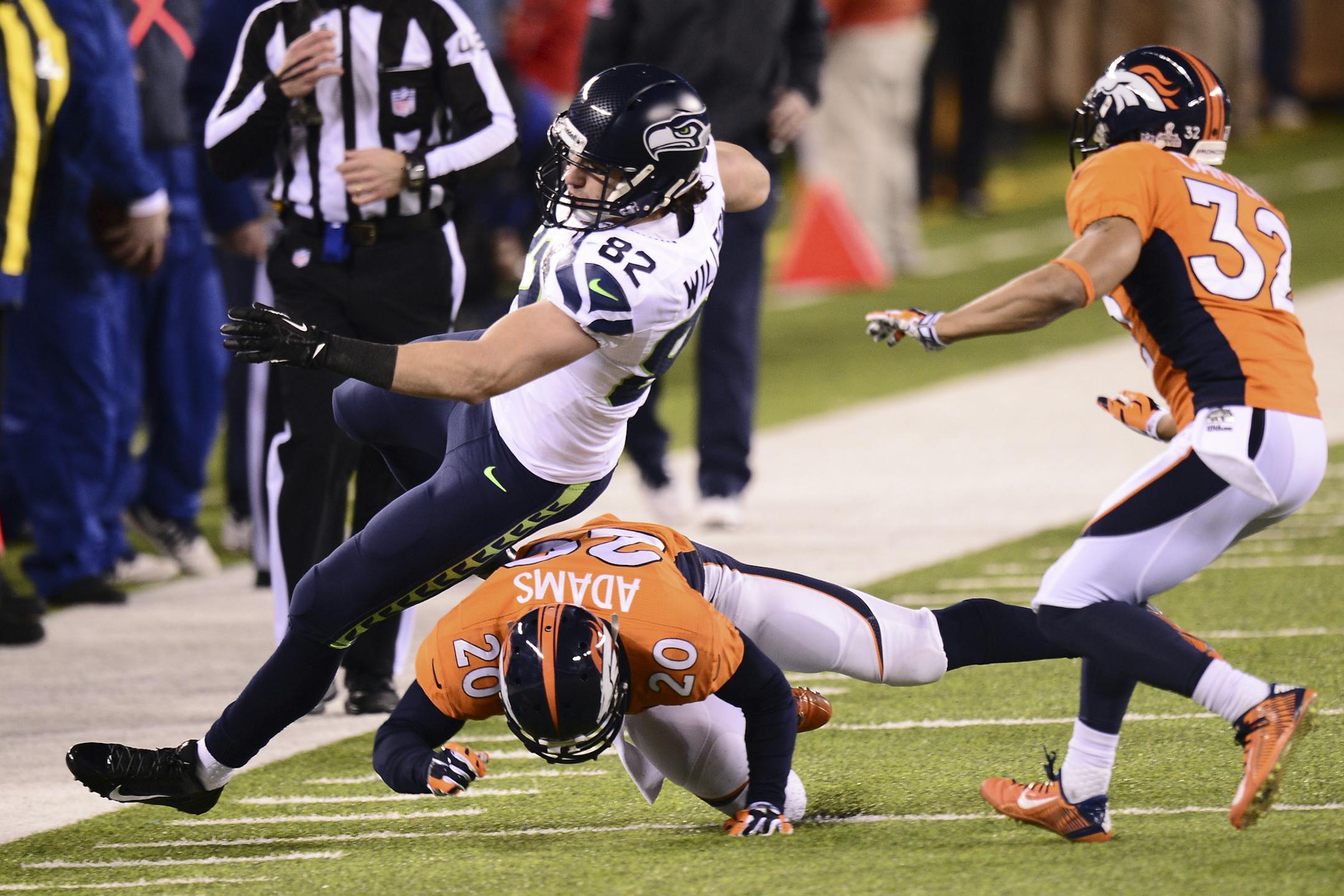 Denver Broncos free safety Mike Adams (20) hits Seattle Seahawks tight end Luke Willson (82) during the second half of the NFL Super Bowl XLVIII football game against the Denver Broncos at MetLife Stadium in East Rutherford, N.J., Feb. 2, 2014. (Ben Solomon/The New York Times)