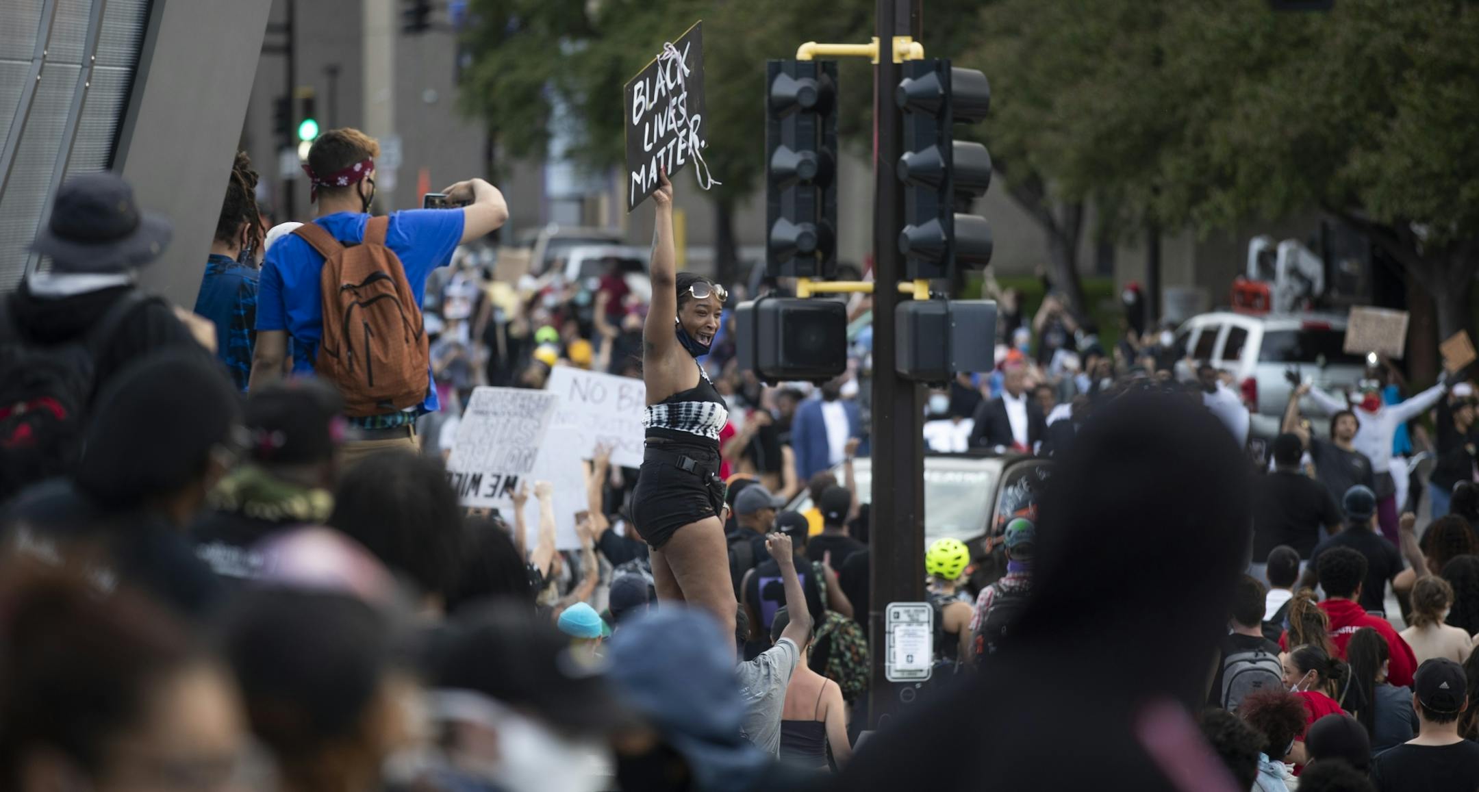 A protestor stood outside of U.S. Bank stadium during Sunday night protests, they are seeking justice for George .