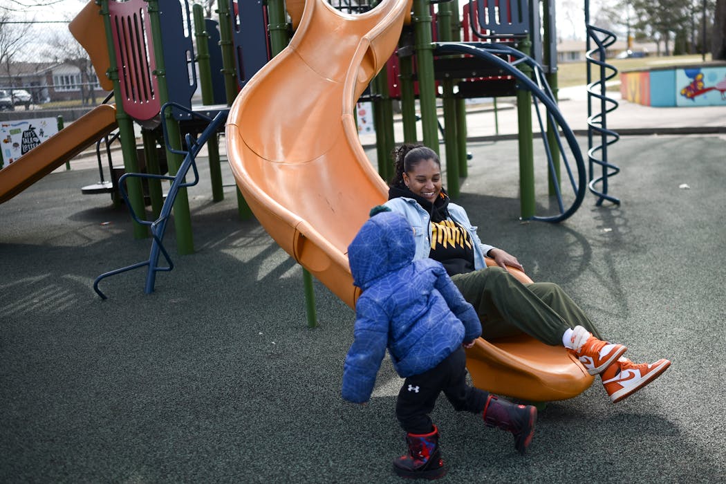 Mercedes Yarbrough followed her 2-year old son Meir down the slide while playing at Central Village Park on Wednesday in St. Paul.
