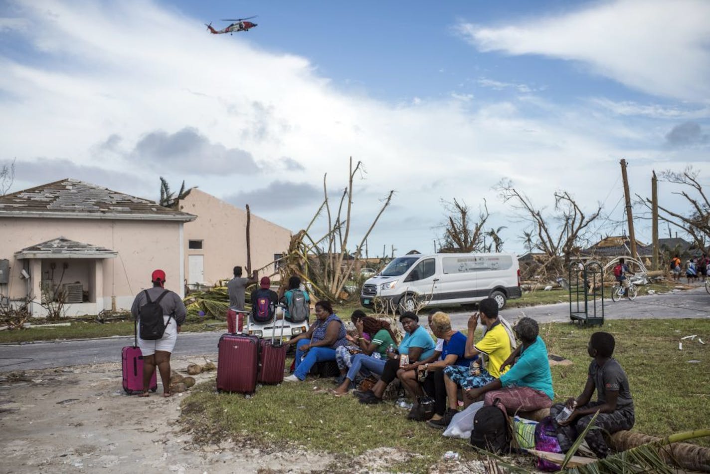 A U.S. Coast Guard helicopter flew overhead as residents waited to be evacuated from Treasure Cay, the Bahamas, on Thursday.