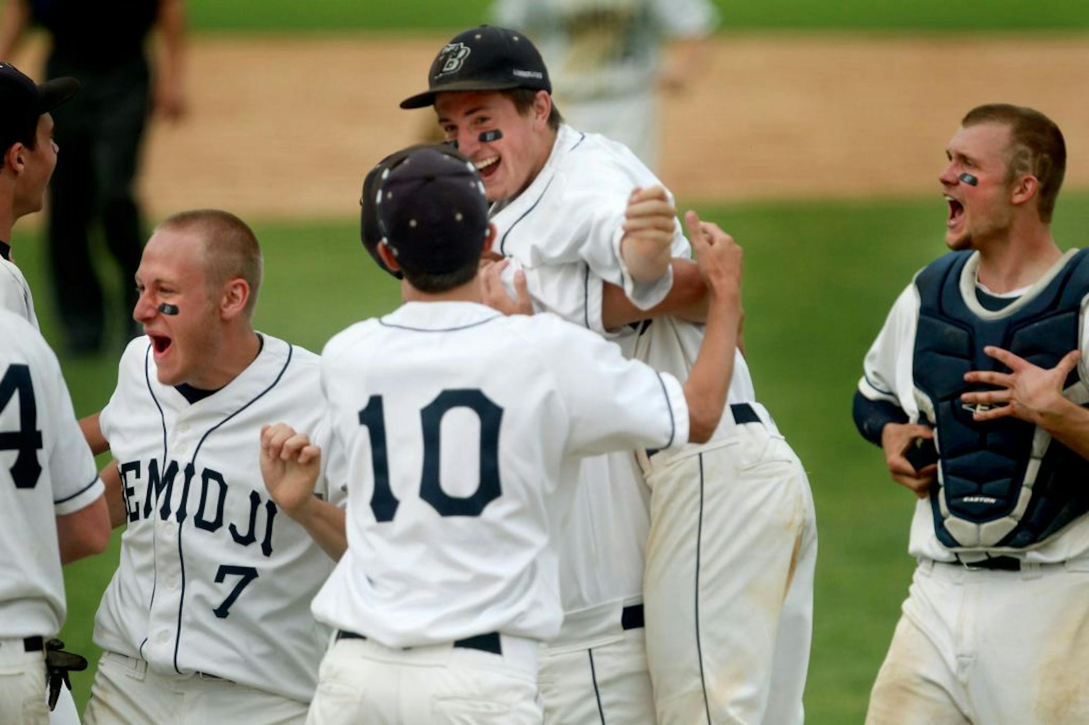 A little early? Eventual winning pitcher Mitch Hendricks, center, was smothered by his teammates after the Lumberjacks thought they won Friday. But Bemidji hadn't won — not after Eden Prairie was granted a reversal of the final strikeout.
