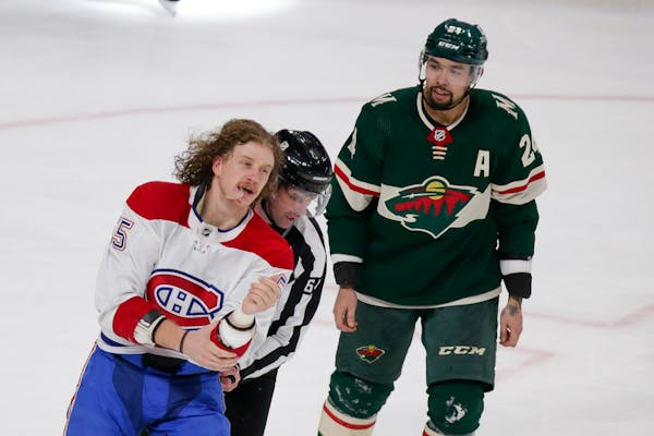 Michael Pezzetta of the Canadiens was led away after a scuffle with Wild defenseman Matt Dumba, right, on Jan. 24.