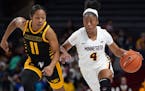 Minnesota Golden Gophers guard Jasmine Powell (4) took the ball down the court as Milwaukee Panthers guard Anaiah Moore (11) raced to defend in the se