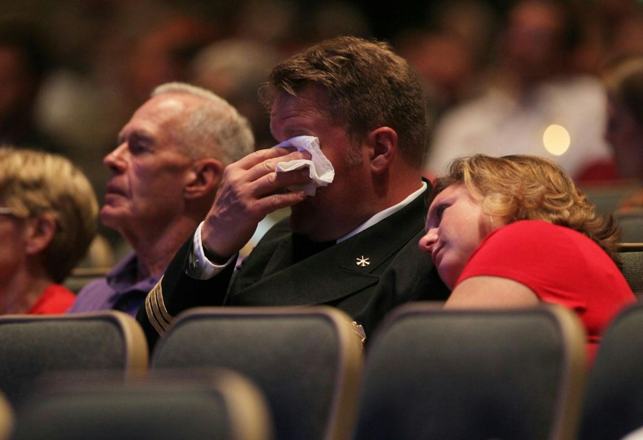 St. Louis Park assistant fire chief Mike Dobesh, with his wife, Sheri, beside him, became emotional during a ceremony at Grace Church in Eden Prairie.