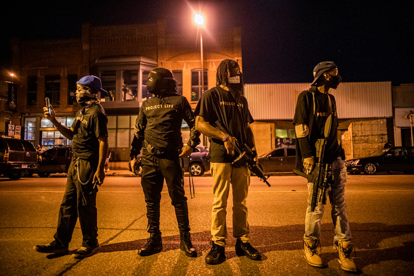 Community members kept watch for trouble along W. Broadway in north Minneapolis on Tuesday night.