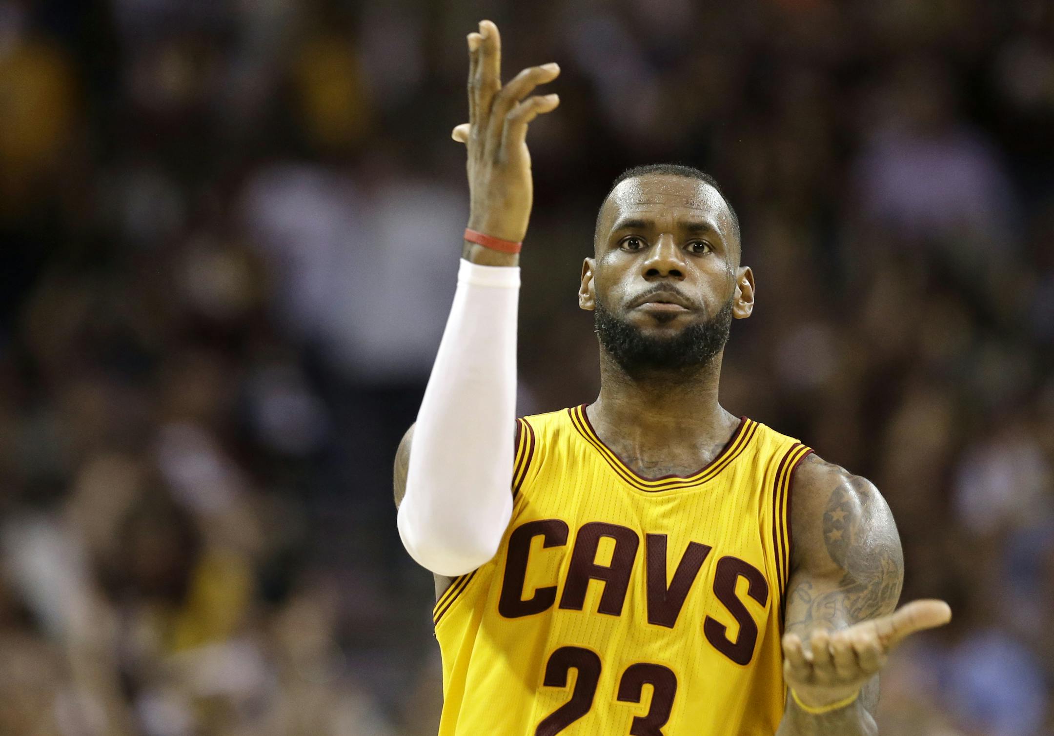 Cleveland Cavaliers forward LeBron James (23) celebrates a play against the Golden State Warriors during the second half of Game 3 of basketball's NBA Finals in Cleveland, Tuesday, June 9, 2015. (AP Photo/Tony Dejak)