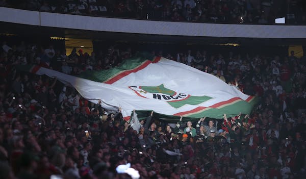Fans a passed a giant flag around the arena before the national anthem during last season's playoffs.