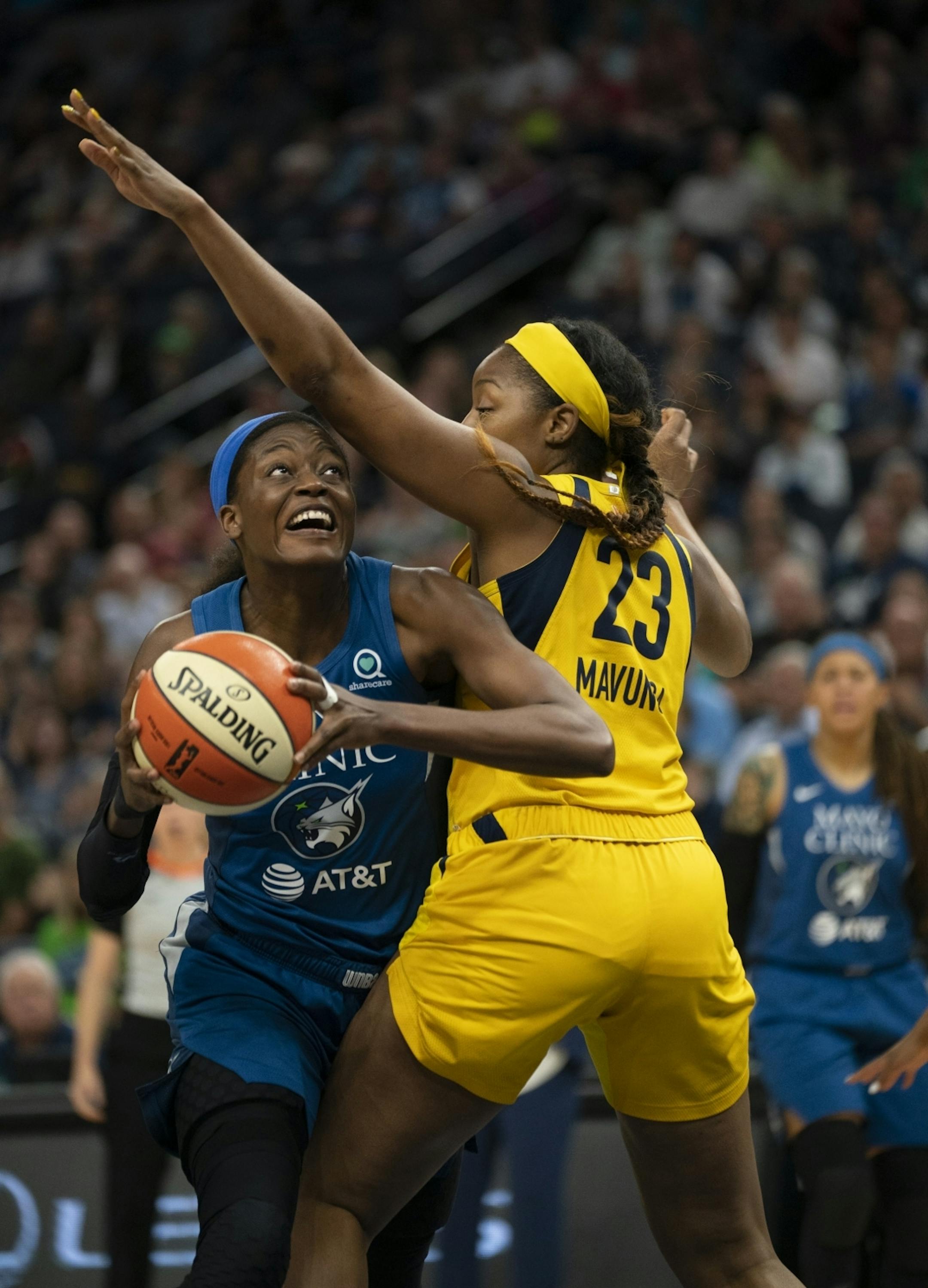 Minnesota Lynx center Temi Fagbenle (14) tried to get a second quarter shot off under Indiana Fever forward Stephanie Mavunga (23).