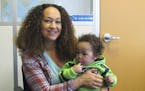 In this March 20, 2017 photo, Rachel Dolezal poses for a photo with her son, Langston in the bureau of the Associated Press in Spokane, Wash. Dolezal,