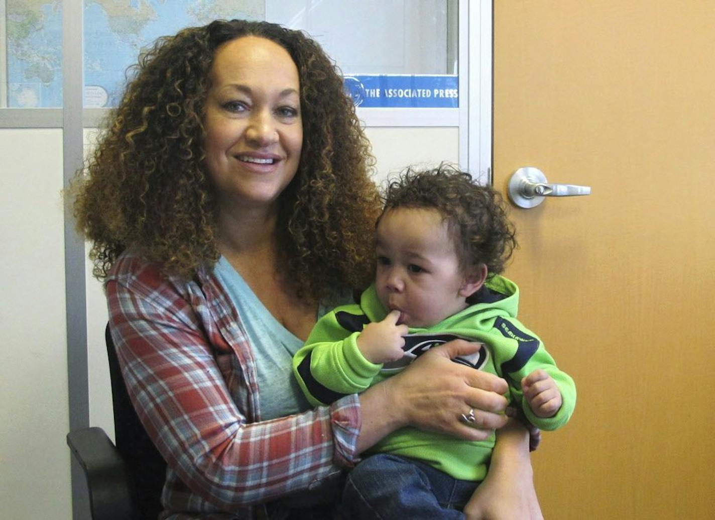 In this March 20, 2017 photo, Rachel Dolezal poses for a photo with her son, Langston in the bureau of the Associated Press in Spokane, Wash. Dolezal, who has legally changed her name to Nkechi Amare Diallo, rose to prominence as a black civil rights leader, but then lost her job when her parents exposed her as being white and is now struggling to make a living.