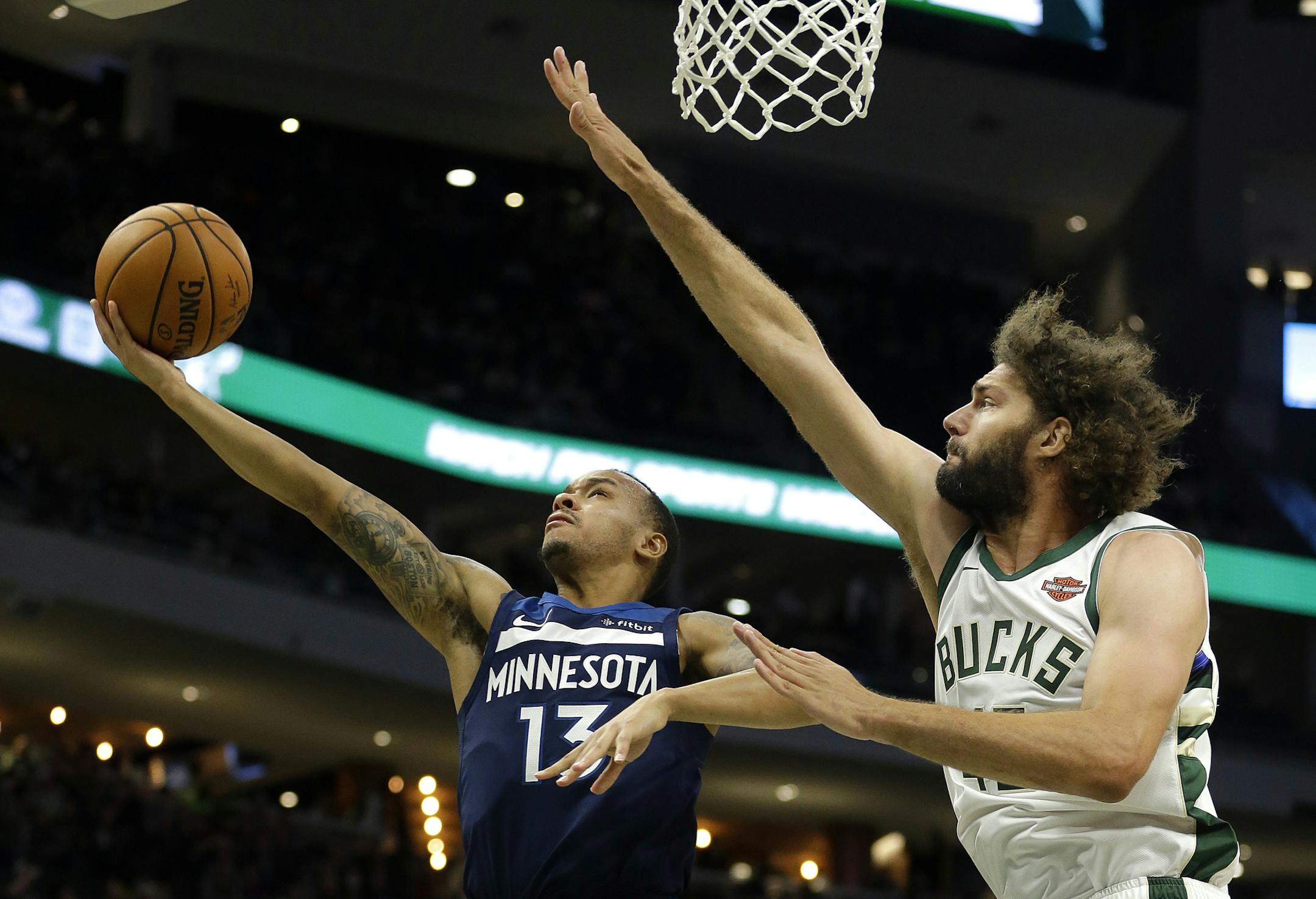Wolves guard Shabazz Napier shot against the Bucks' Robin Lopez during the second half of a preseason NBA game Thursday.