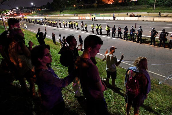 Protestors stood facing Interstate 94 after police forced them off the freeway near Dale St. in St. Paul on July 11, 2016. The protest was in response