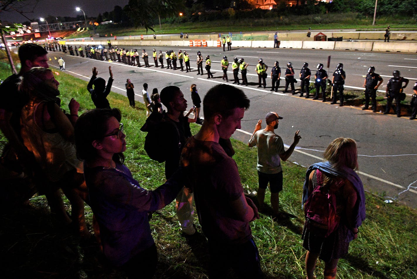 Protestors stood facing Interstate 94 after police forced them off the freeway near Dale St. in St. Paul on July 11, 2016. The protest was in response to the fatal shooting of Philando Castile by a police officer. ] Isaac Hale &#xef; isaac.hale@startribune.com