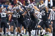 Gophers defensive lineman Jah Joyner (17) celebrates after recovering a strip sack fumble that he also forced on Michigan State quarterback Sam Leavit
