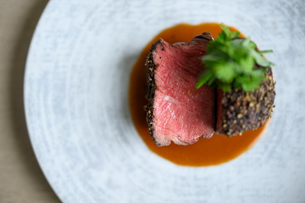 The pepper-crusted filet with veal-peppercorn jus is among the fish and meat entrees at Dario.