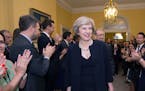 Staff clap as new Prime Minister Theresa May walks into 10 Downing Street, London, Wednesday, July 13, 2016. David Cameron stepped down Wednesday afte