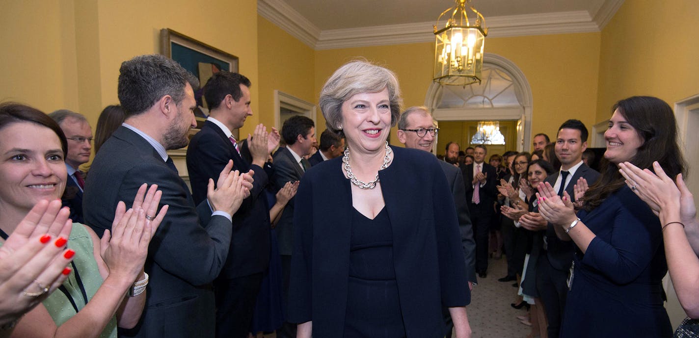 Staff clap as new Prime Minister Theresa May walks into 10 Downing Street, London, Wednesday, July 13, 2016. David Cameron stepped down Wednesday after six years as prime minister. (Stefan Rousseau/Pool Photo via AP) ORG XMIT: MIN2016071313040114