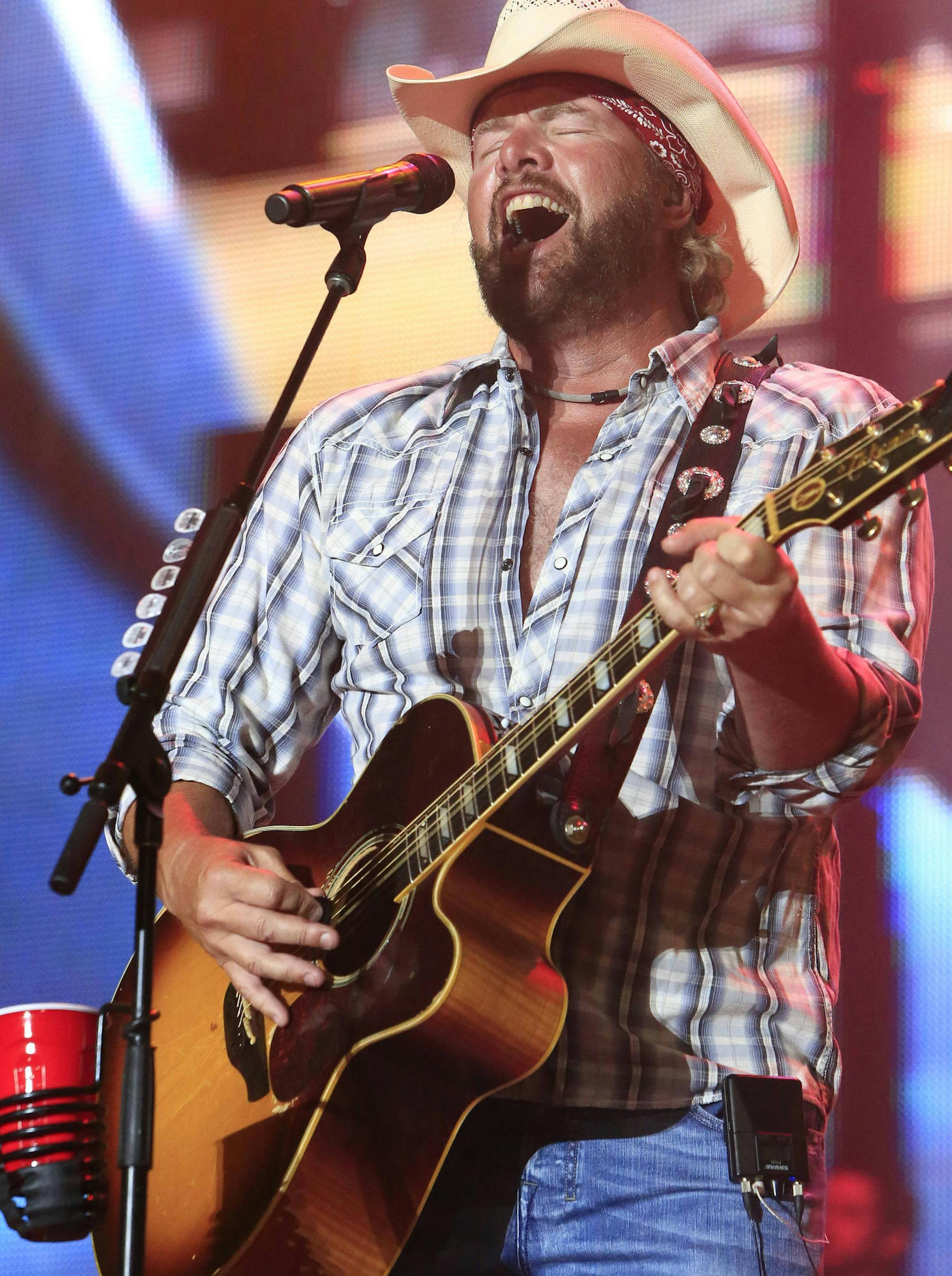 Toby Keith performs at the Oklahoma Twister Relief Concert at the Gaylord Family-Oklahoma Memorial Stadium on Saturday, July 6, 2013 in Norman, Okla. (Photo by Alonzo Adams/Invision/AP)