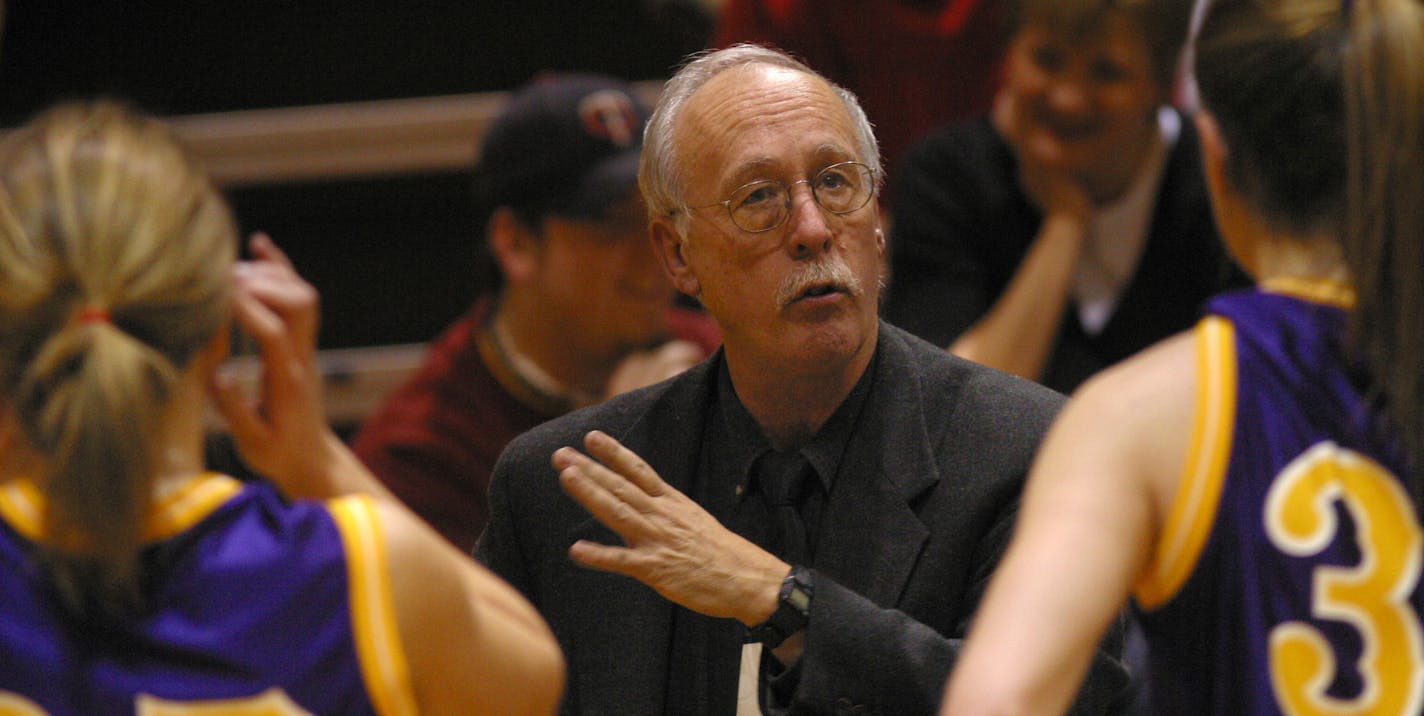 Rochester, MN 1/17/2004 Girls coach Myron Glass goes over the game plan courtside during a time-out against Kingsland