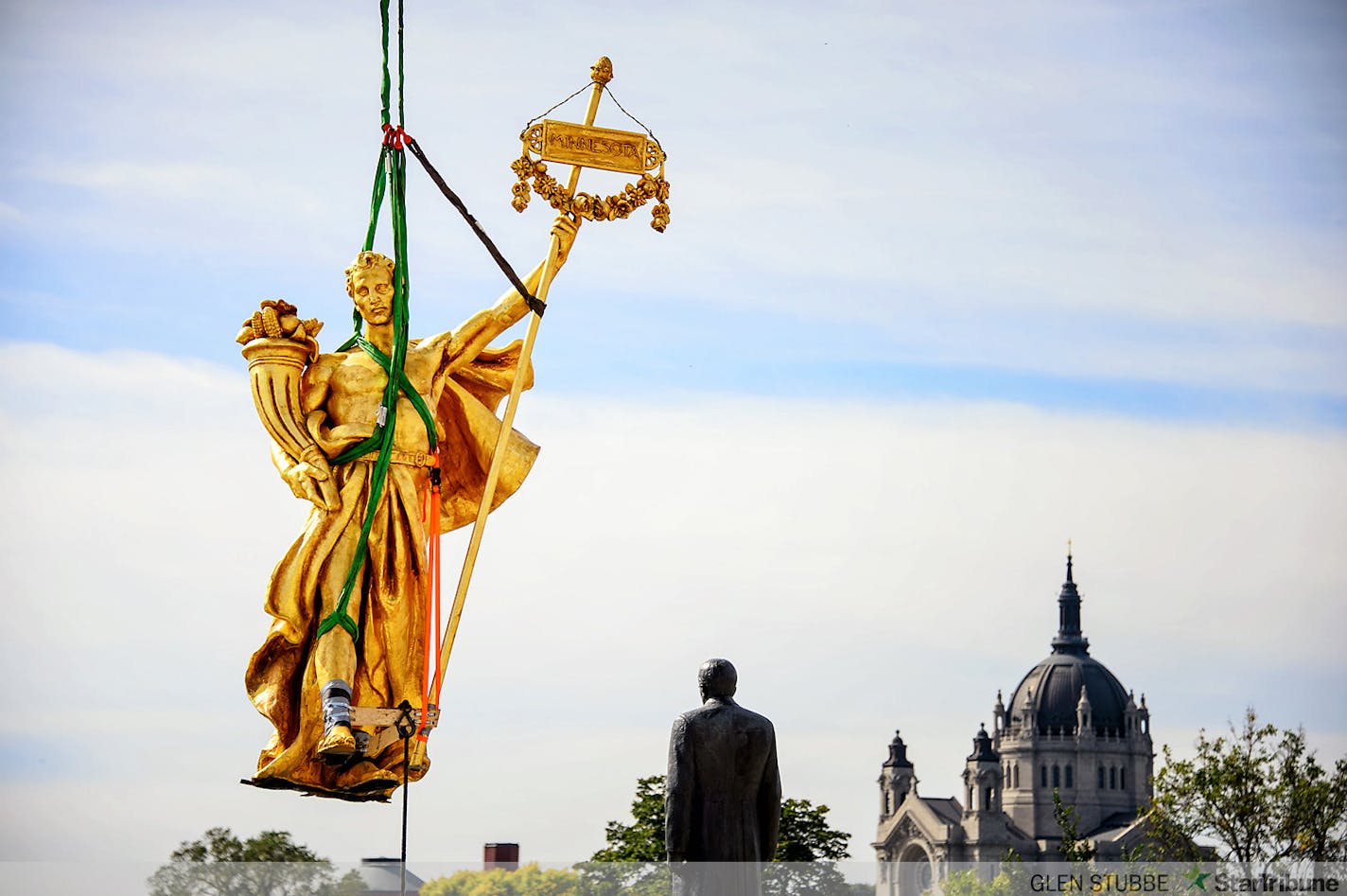 The charioteer figure who guides the golden horses on the Minnesota State Capitol Building's Quadriga statue were temporarily removed on Tuesday, September 23 to repair corrosion discovered at the statue's base. The repair is expected to take approximately three months when charioteer will return to the Quadriga.    ]   Tuesday, September  23, 2014   GLEN STUBBE * gstubbe@startribune.com